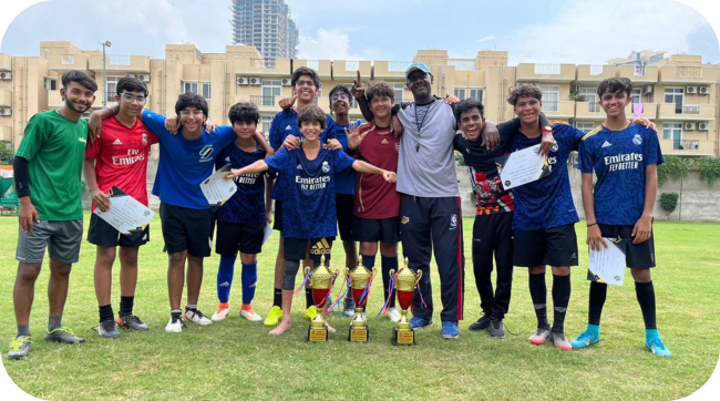 Players playing football at sports academy event